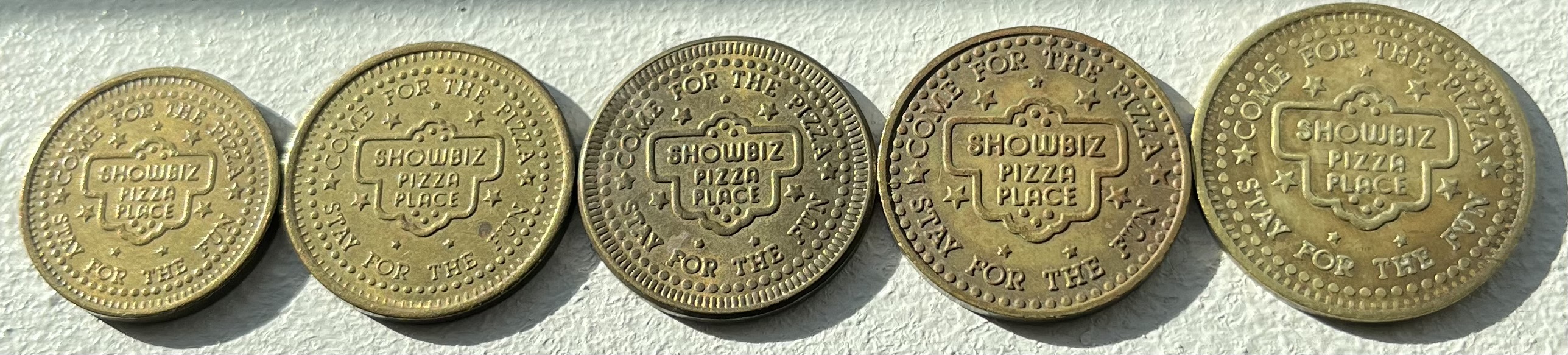 Various Sized Showbiz Pizza Place Tokens